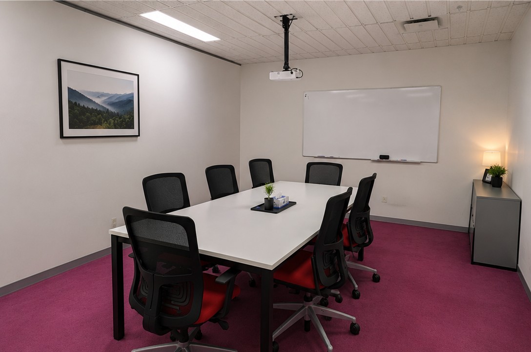 Meeting room with whiteboard, boardroom table and seating for eight